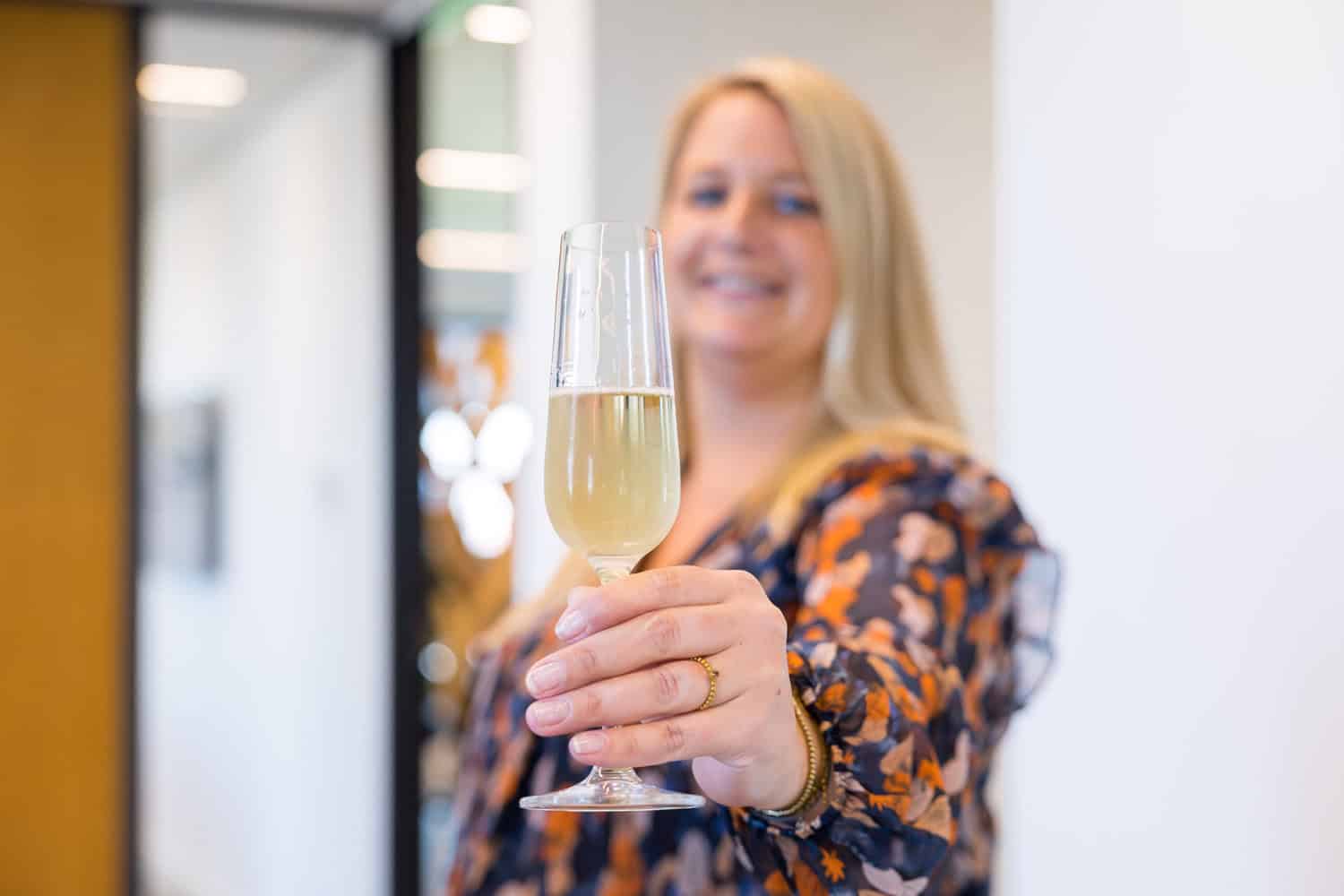 Marloes proost met een glaasje champagne.